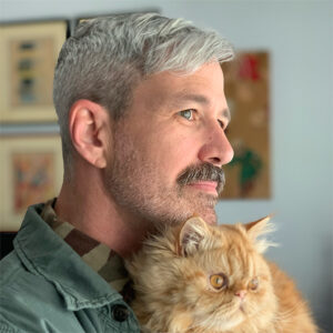 A picture of Professor Emmons with an orange cat.